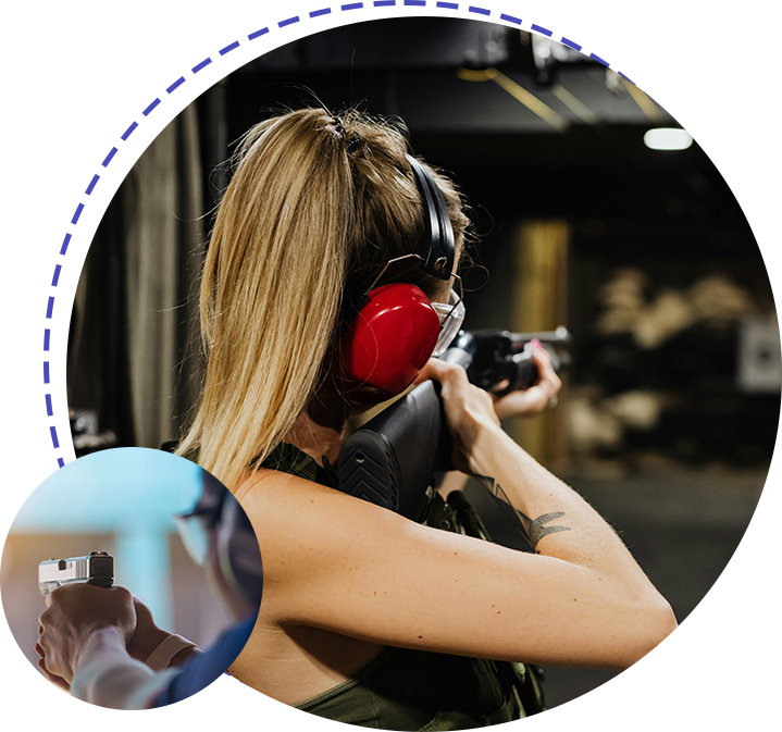 A woman wearing ear muffs and holding a gun.
